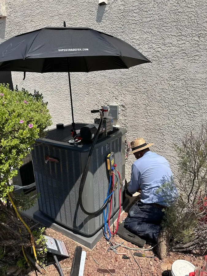 HVAC technician performing outdoor AC maintenance in Long Beach